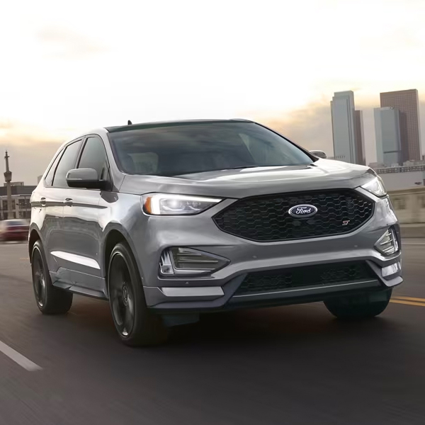 Gray 2024 Ford Edge driving through the city on the interstate