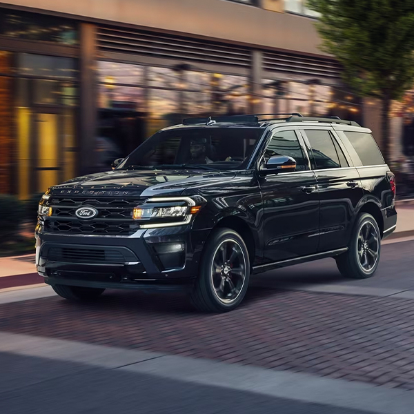 The stylish grille of the Ford Expedition Limited Stealth Performance Edition features Painted Dark Carbonized Gray bars with Painted Ebony Black mesh. Behind it, there's a 3.5L EcoBoost