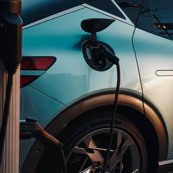 Parked GV60 plugged into an electric charger.