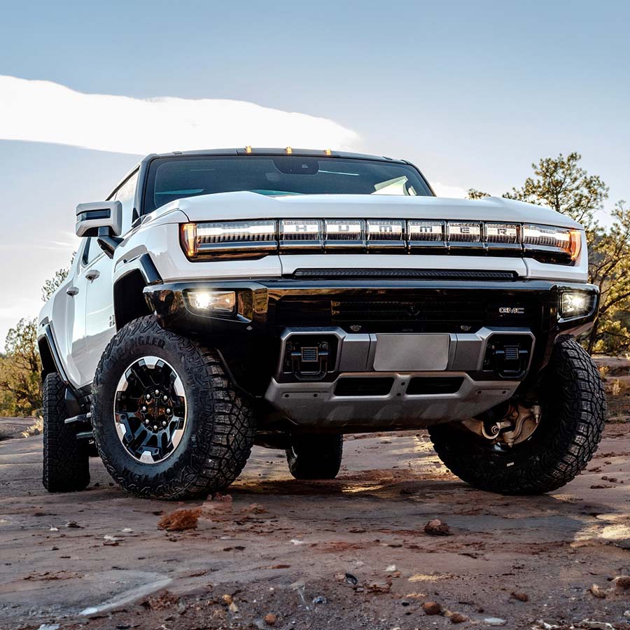 Low front 1/4 shot of GMC HUMMER EV Pickup parked on clay