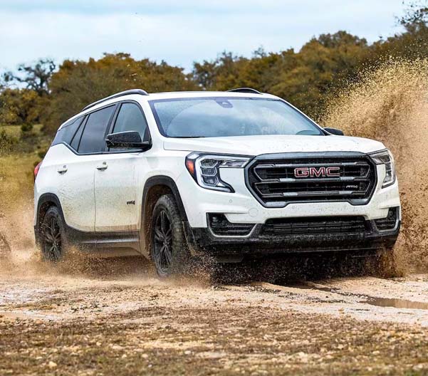 2024 GMC Terrain driving off-road through water and mud