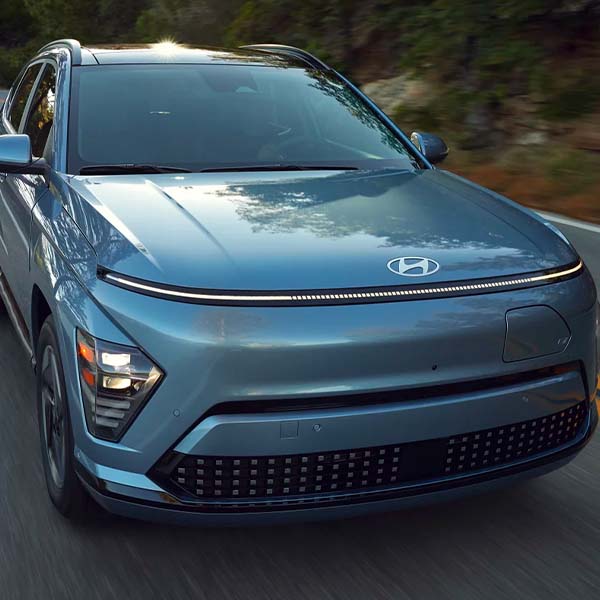 Action shot of the 2024 Hyundai Kona Electric showing off it's all-electric range up to 261 miles