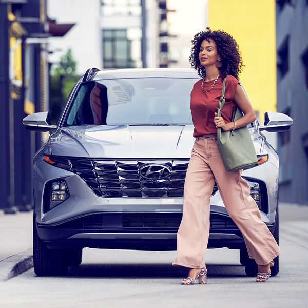 Woman walking infront of Hyundai Tucson