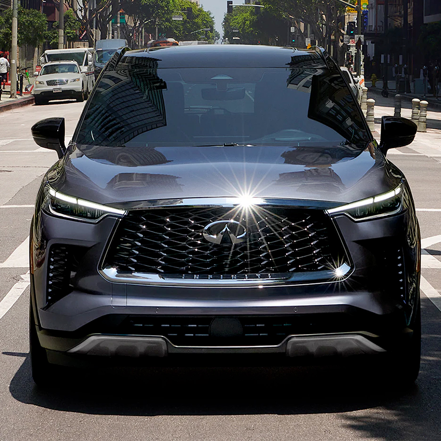 Front exterior view of 2024 INFINITI QX60 Crossover SUV highlighting LED headlights