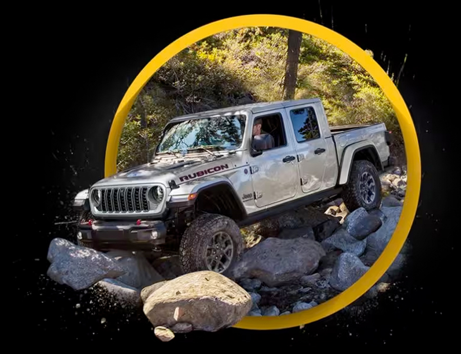 A silver 2024 Jeep Gladiator Rubicon crawling over boulders off-road.
