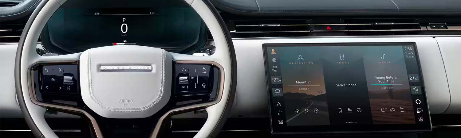 Interior shot of a 2024 Range Rover Sport steering wheel and navigation screen.