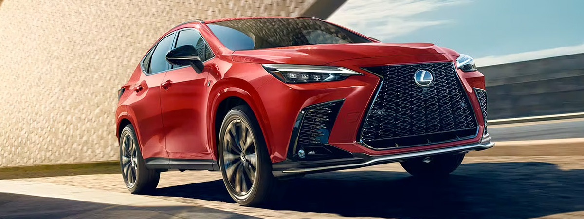 Side shot of 2024 Lexus NX driving down road in daytime.