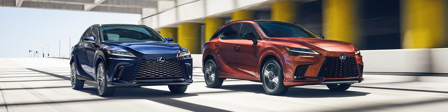 Exterior of two 2024 RX vehicles driving side by side. One shown in Nightfall Mica and the other in Copper Crest.