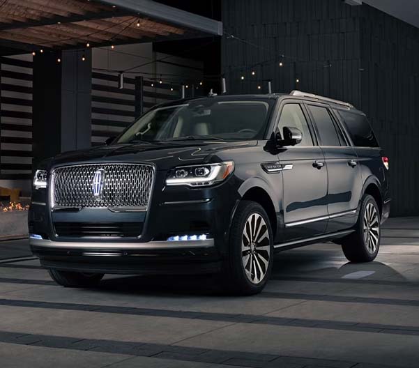 2024 Lincoln Navigator parked in front of modern building with exterior lights on