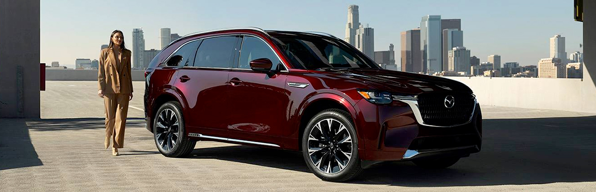 Woman walking towards 2024 Mazda CX-90