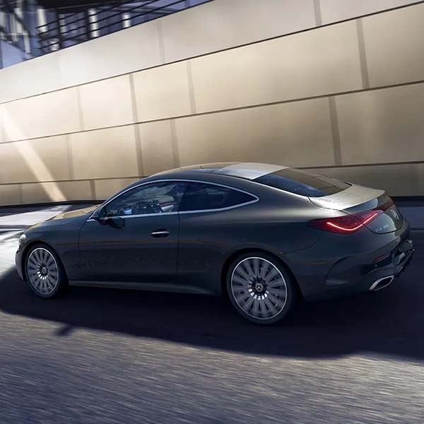 Exterior shot of a 2024 Mercedes-Benz CLE driving in a city.