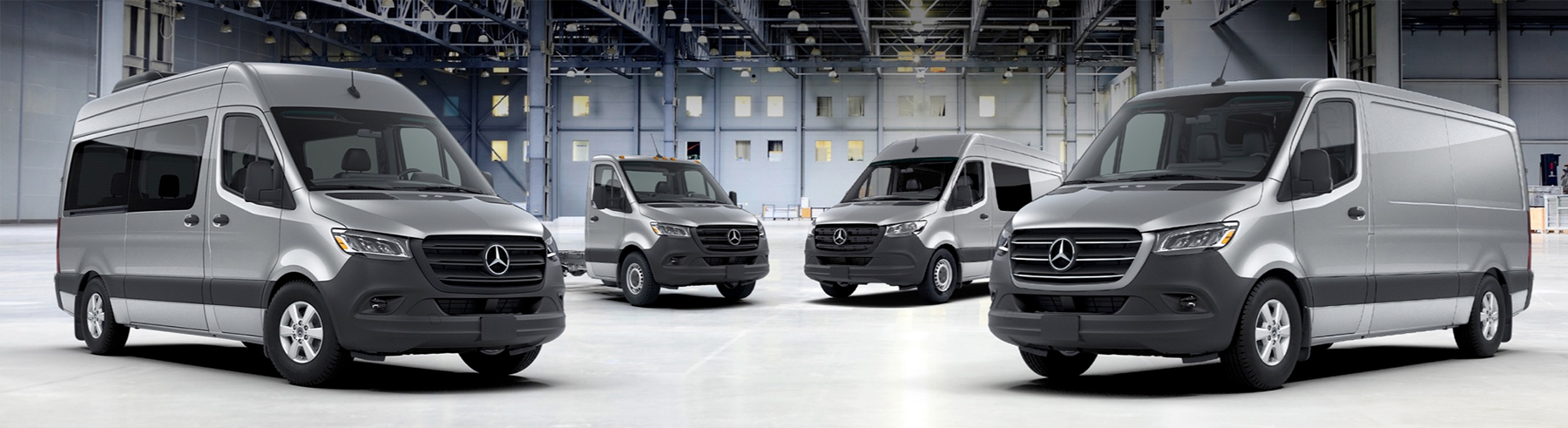 2024 Mercedes-Benz Sprinter vans in a large, empty warehouse setting.