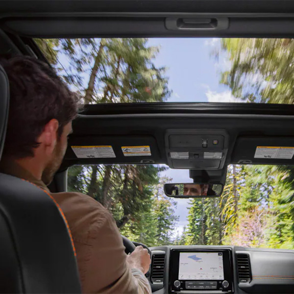 Interior shot showing off dashboard and power sliding glass moonroof of 2024 Nissan Frontier