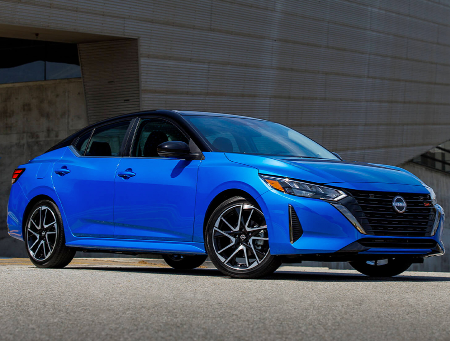 2024 Nissan Sentra in Electric Blue Metallic in motion on a city street.