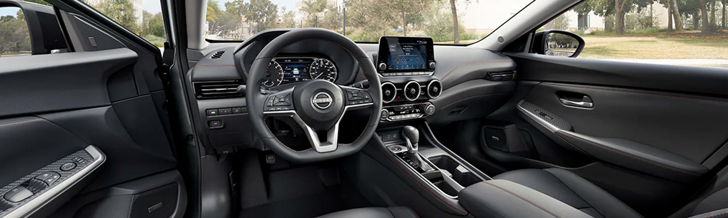 2024 Nissan Sentra showing black interior of front seats and cockpit.