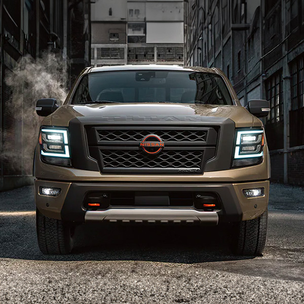 Head on shot of the 2024 Nissan Titan parked in alleyway of city