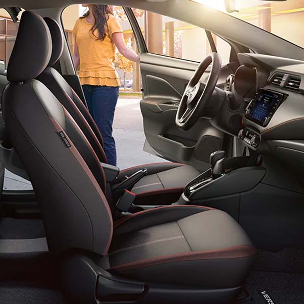 Interior shot of the 2024 Nissan Versa displaying it's 7-inch touchscreen and premium cloth seat trim