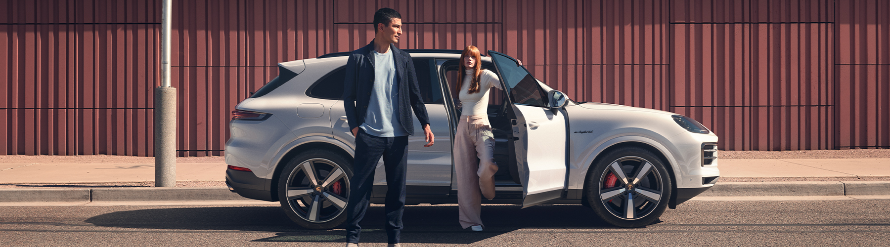 2024 Porsche Cayenne S E-Hybrid parked with 2 people getting out of vehicle