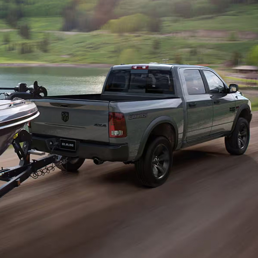 Rear view of 2024 Ram 1500 Classic towing a boat