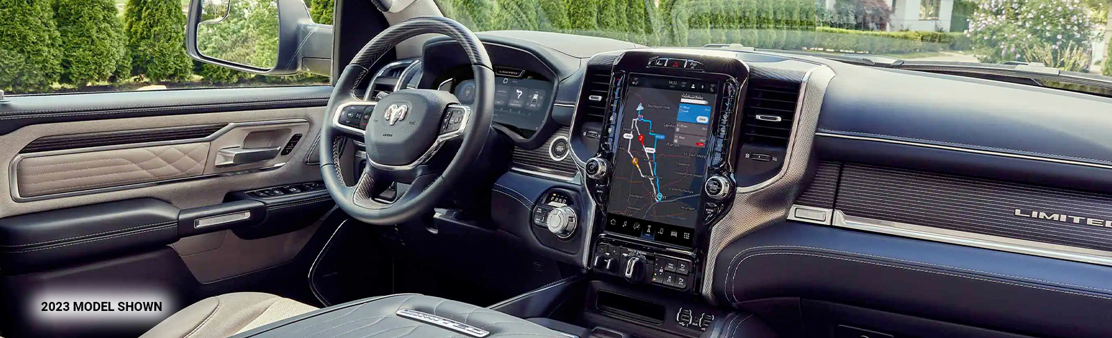 The interior of the 2023 Ram 1500 with the large Uconnect touchscreen displaying a navigation map.