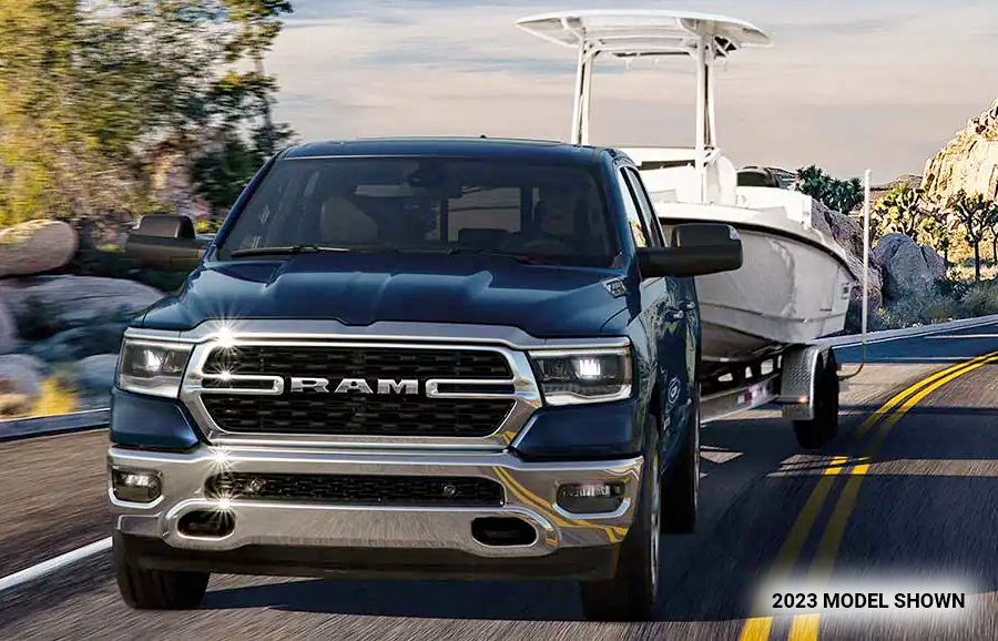 The 2023 Ram 1500 towing a boat.