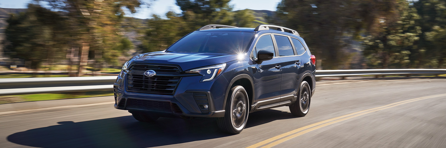 Front of an Ascent Onyx in Cosmic Blue driving through the hills.