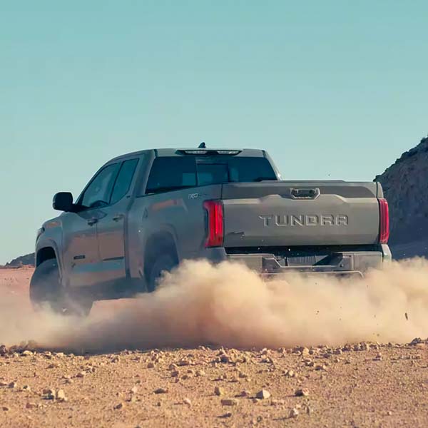Back view of the 2024 Toyota Tundra kicking up dust