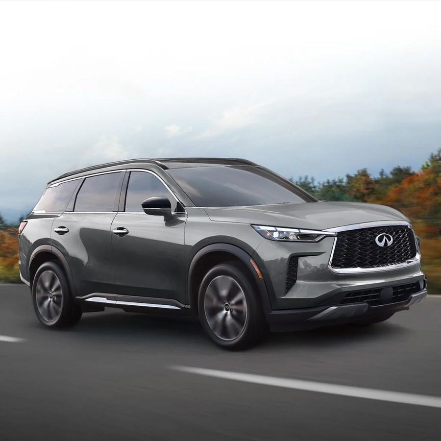 2025 INFINITI QX60 Graphite Shadow color driving on city highway