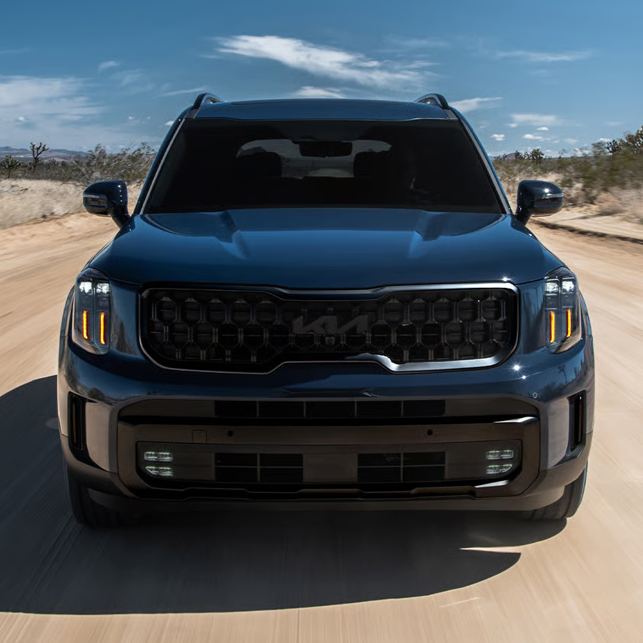 2025 Kia Telluride X-Line, front view, driving down a desert road