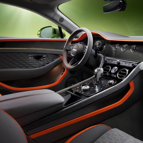 The front cabin of the new hybrid Bentley Continental GT Speed with a exclusive Speed colour split with Gravity Grey main hide and Mandarin secondary hide