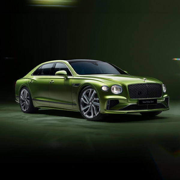 Green Bentley Flying Spur parked in studio setting.