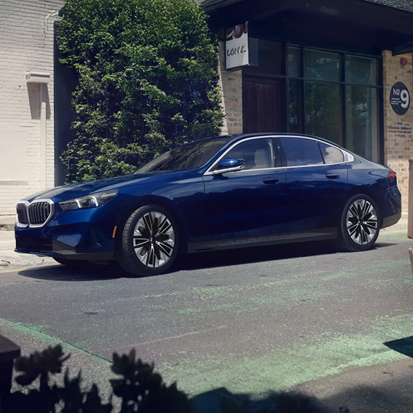 Front view of a blue 2024 BMW 5 Series parked