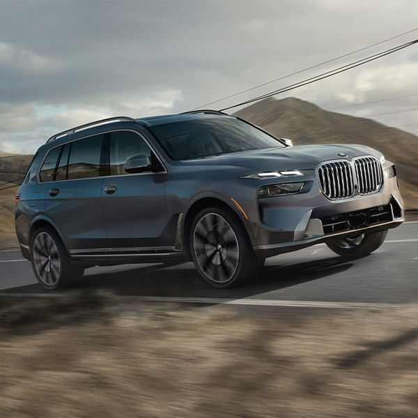 2024 BMW X7 in motion driving down a road