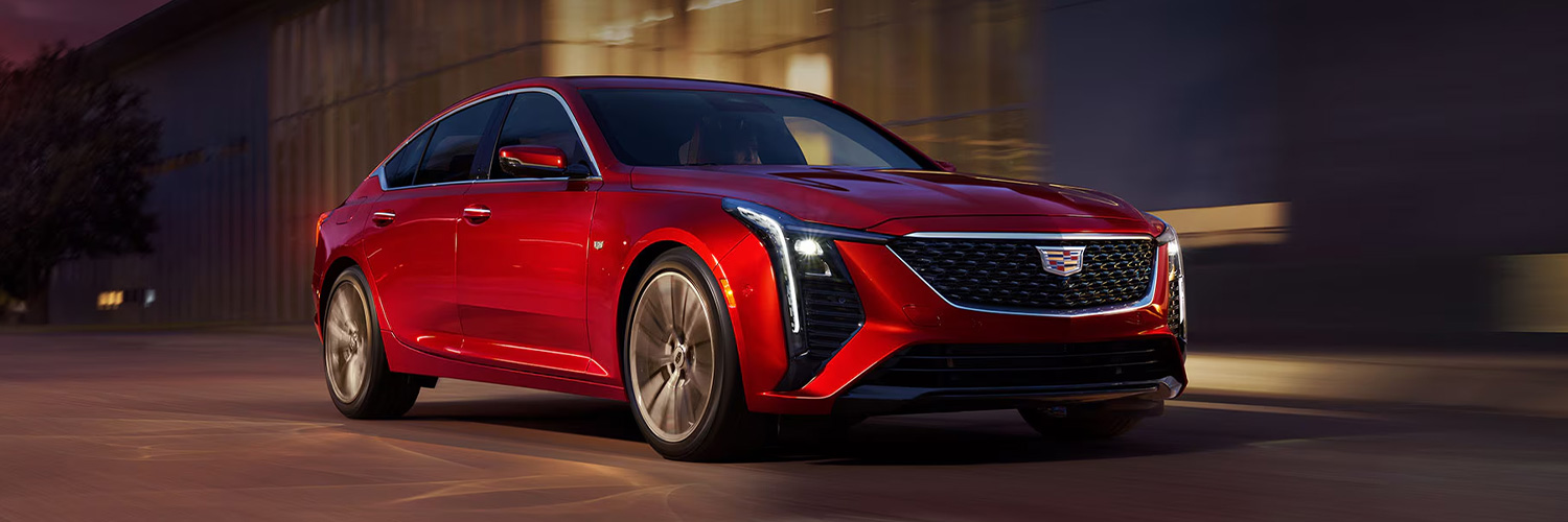 Side shot of the 2025 Cadillac CT5 driving down city road