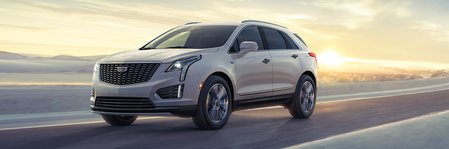 Front 3/4 shot of the 2025 Cadillac XT5 driving down road.
