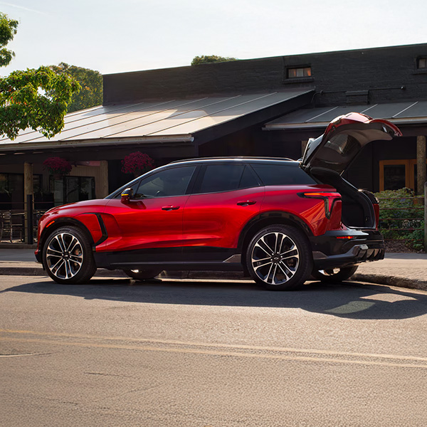 Side profile shot of the 2025 Chevrolet Blazer EV parked in front of building