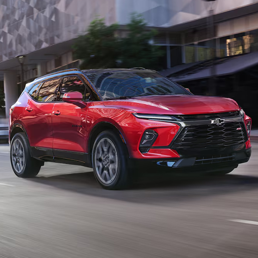 A Red 2025 Chevy Blazer Driving on city road.