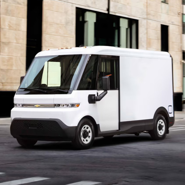 A BrightDrop Van Driving Through City Streets