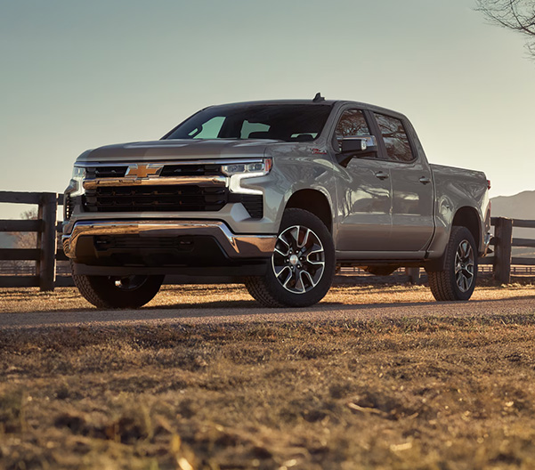 chevy truck parked in front of fence