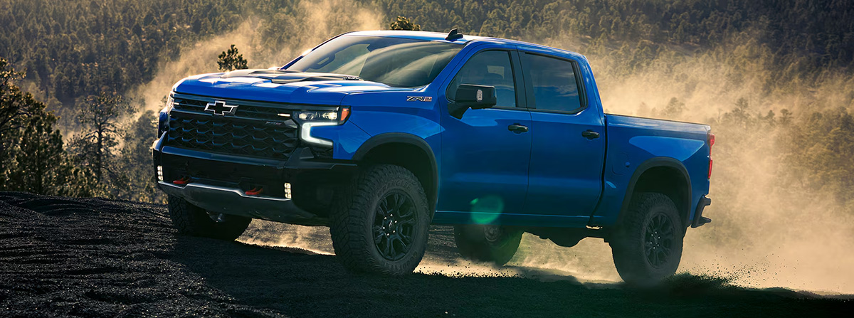 Side profile shot of the 2025 Chevrolet Silverado 1500 driving up mountainside