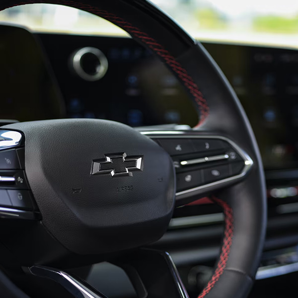 Front interior view of 2025 Chevy Silverado EV under a clear blue sky