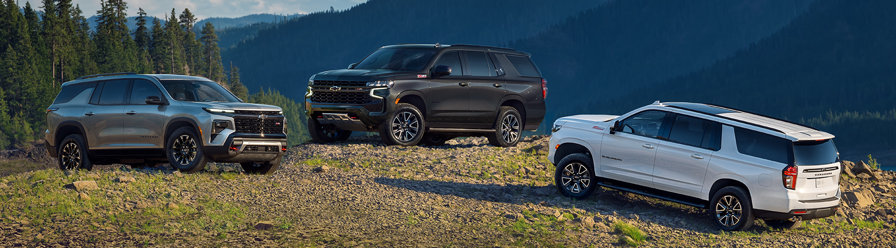 New Chevy Suburban lineup in front of mountain