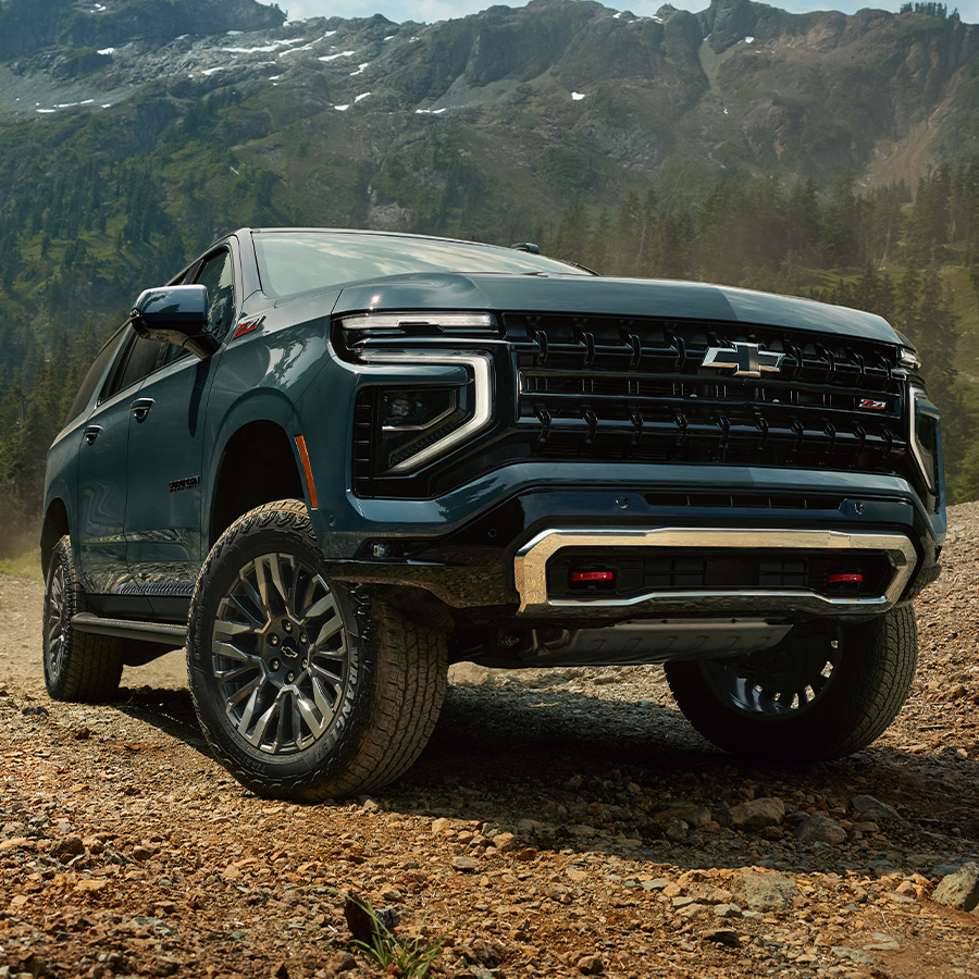 New Chevy Suburban in Front of Mountain Range