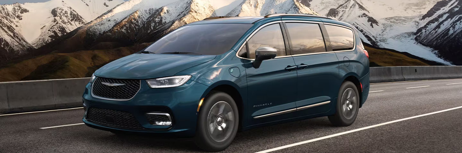 2025 Chrysler Pacifica Plug-in Hybrid cruising down a mountainous road