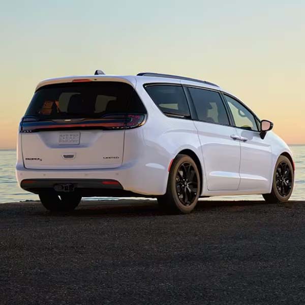 A white 2025 Chrysler Pacifica parked on a waterfront lot