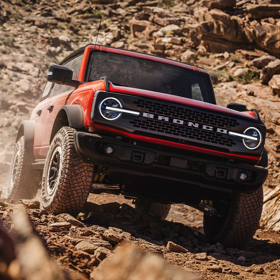 A Bronco® SUV is being driven up a steep, rocky incline