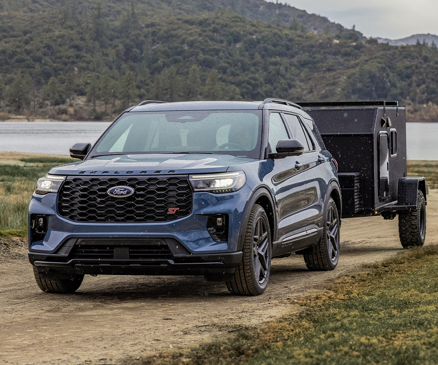 2025 Ford Explorer® ST model in Vapor Blue Metallic towing a trailer