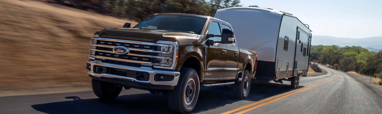 Ford F-250 towing a trailer on winding road