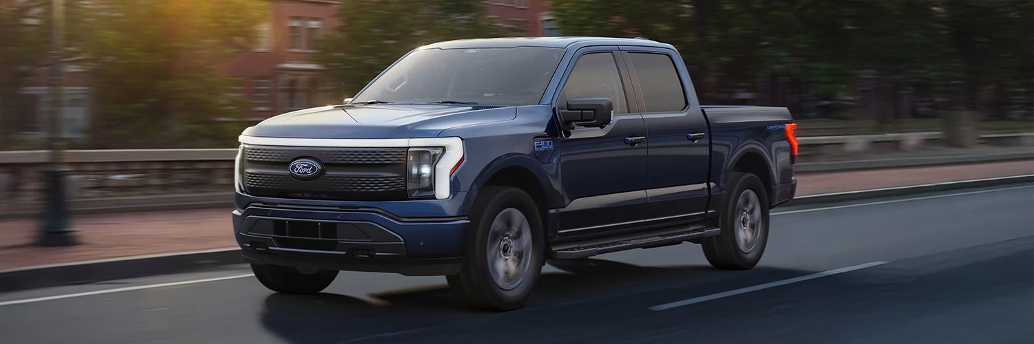 Side shot of the 2025 Ford F-150 Lightning driving down road