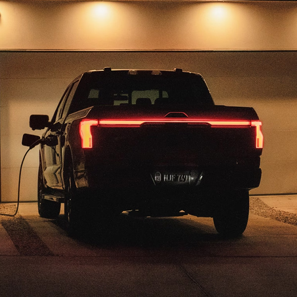 Rear view of Ford F-150 Lightning charging at home